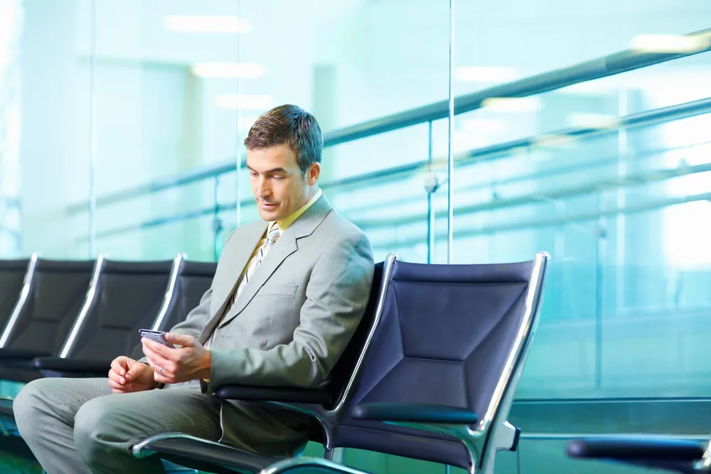 Someone working on a laptop while waiting to travel
